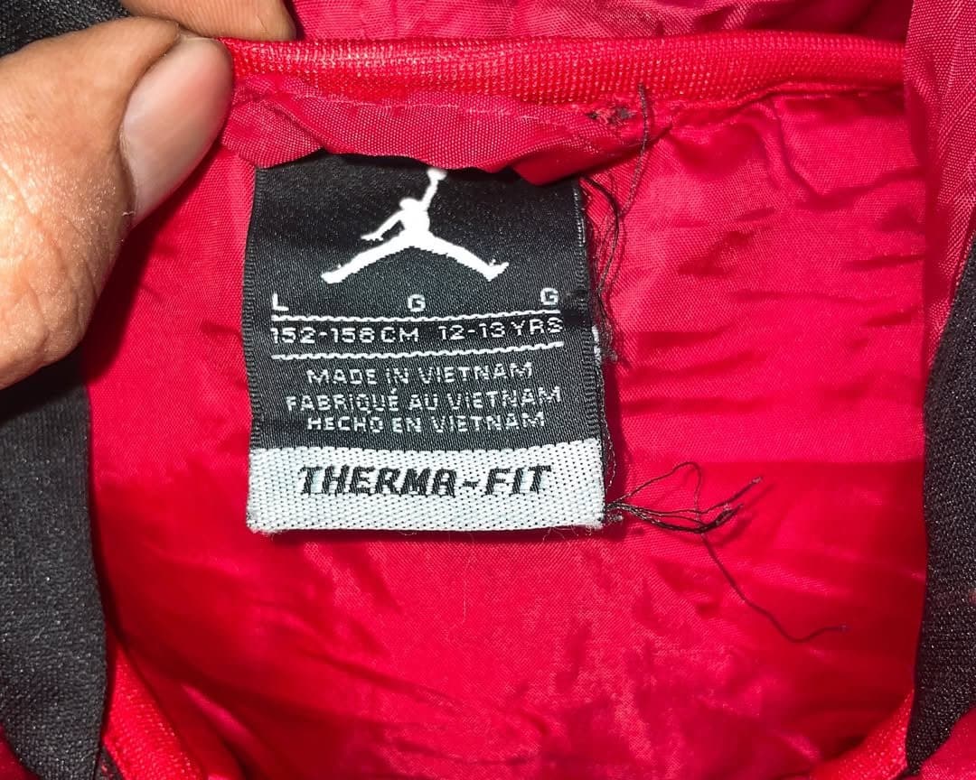 Branded thrift puffer jacket India close-up