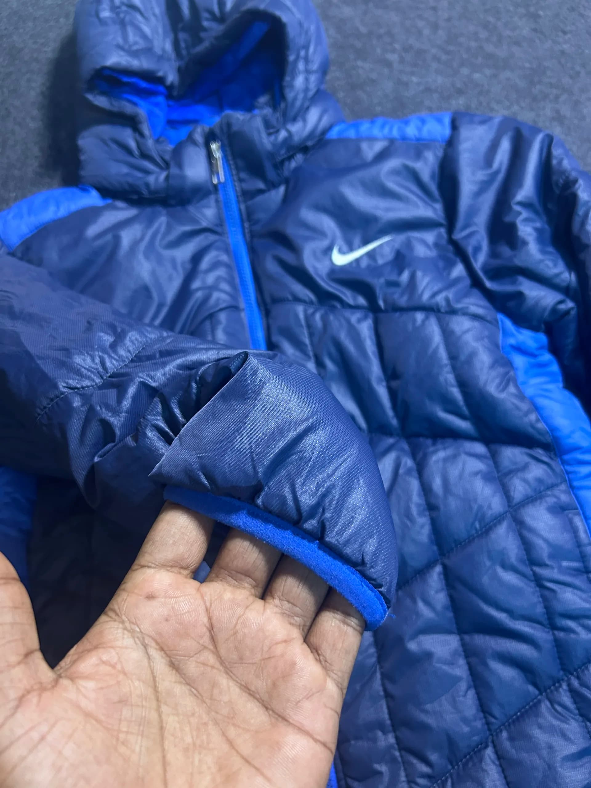 Nike thrift puffer jacket India close-up
