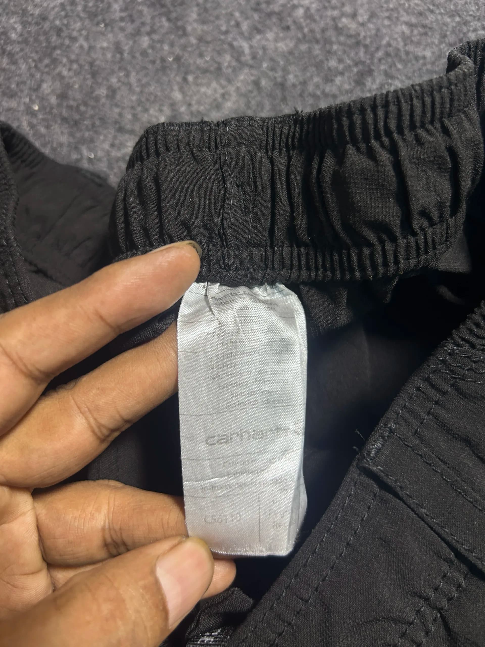 Carhartt thrift track pants India close-up
