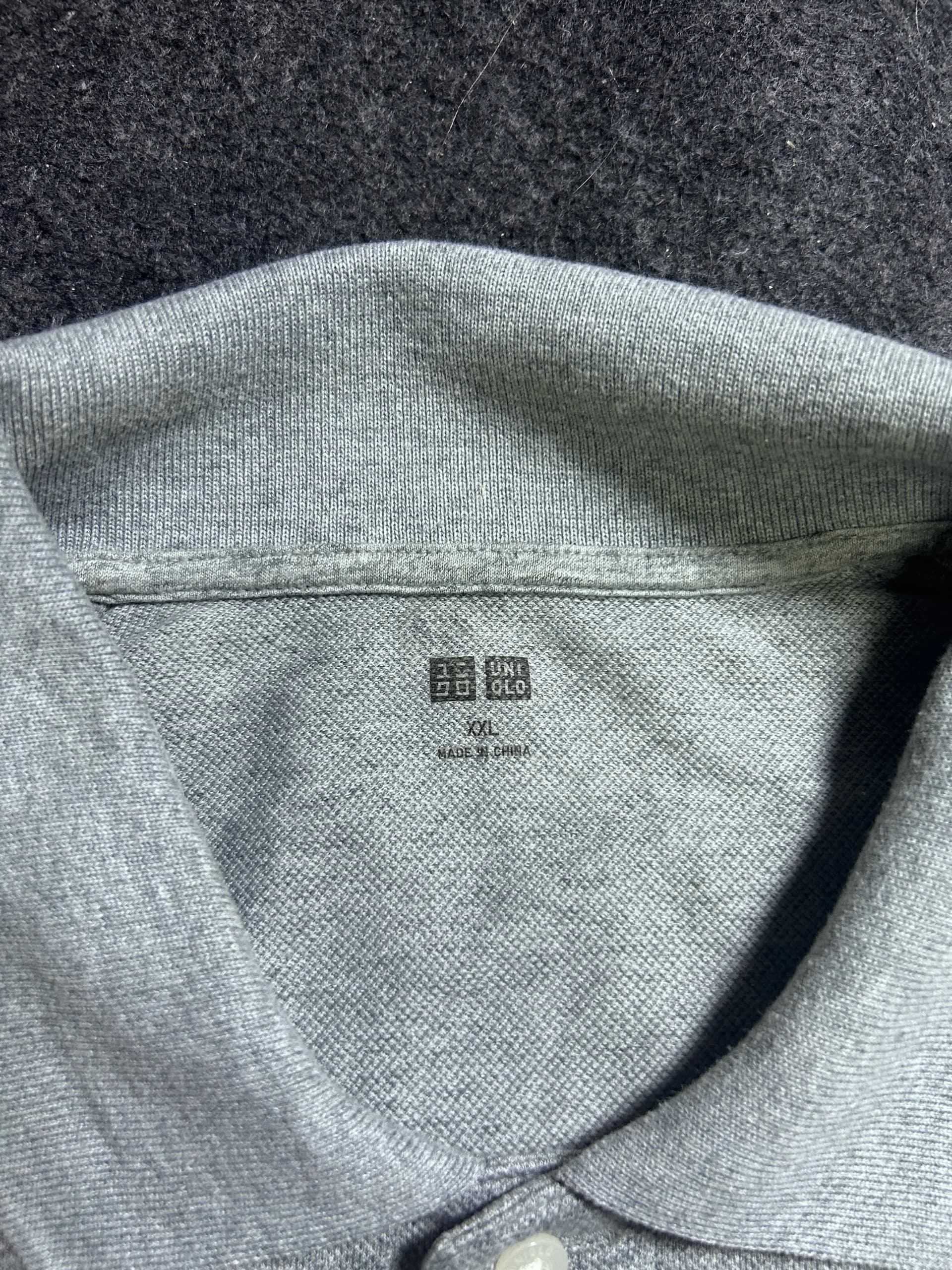 Uniqlo thrift polo shirt India close-up