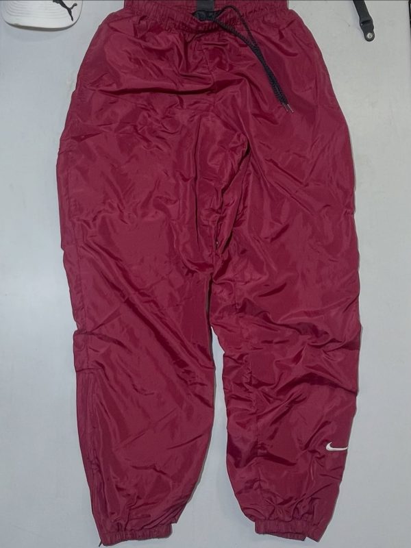 Nike dark red baggy track pant with inner net size S 

Waist 26-32

Length 41